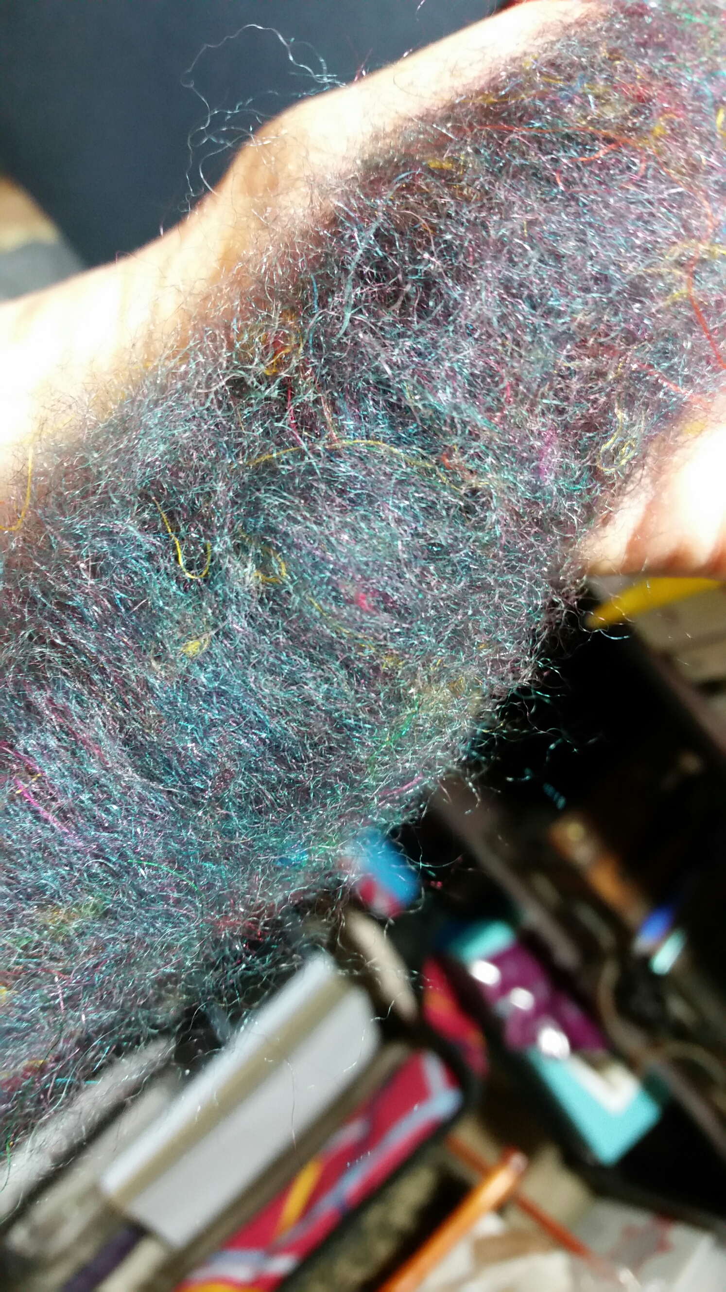 Rolag of hand-carded SGY Riptide and Black Cherry BFL-Silk Blend, with sari silk fibers included.