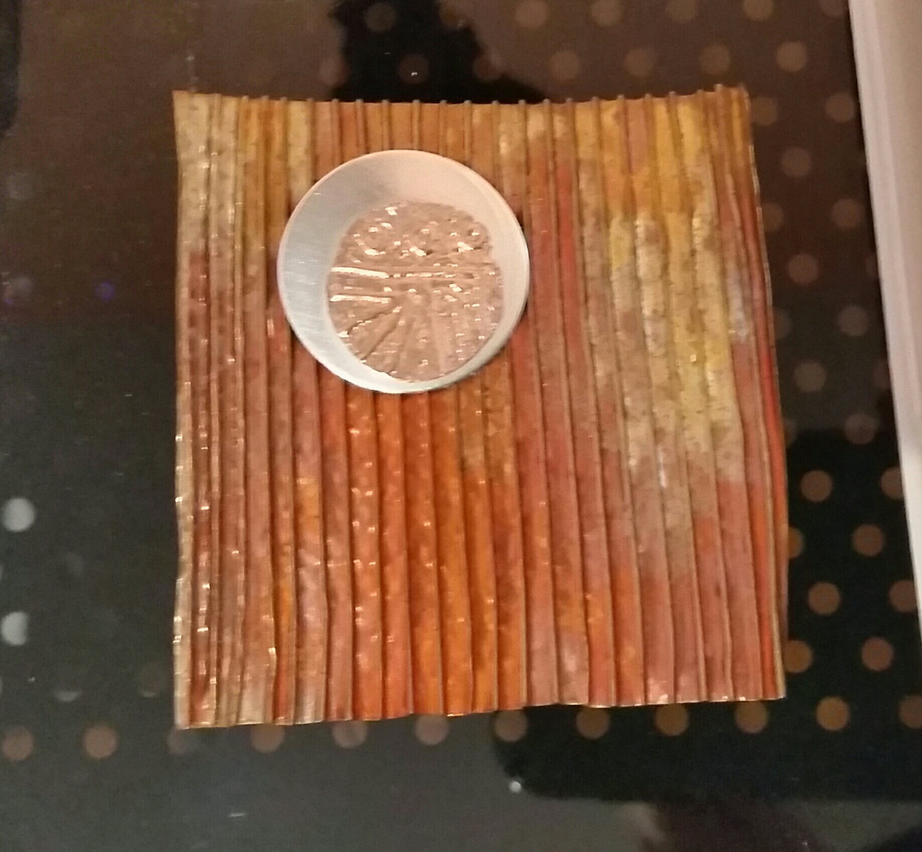 Sweat-soldered disks on a copper background
