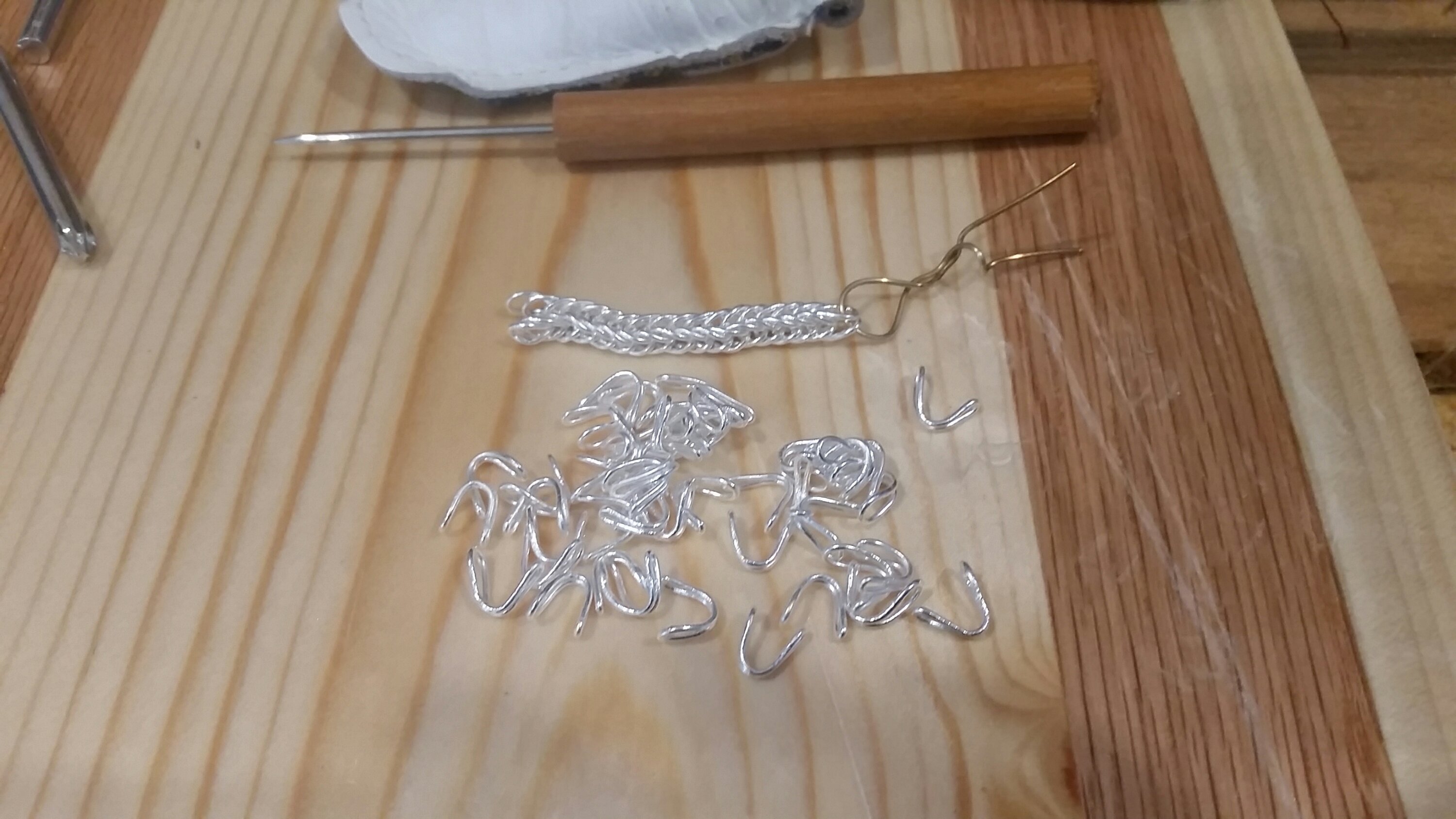 The start of a fine silver double loop-in-loop chain and some prepared links