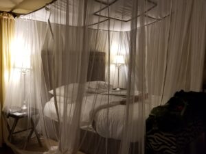 Our mosquito-netted bed, lit up and lovely